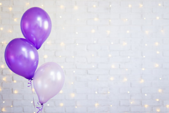 Birthday Party Concept - Air Balloons Over Brick Wall Background With Lights