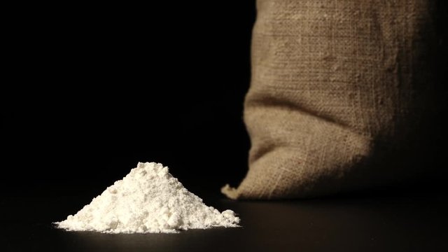 STOP-MOTION: White flour heap growing near a sac