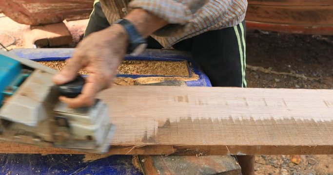 carpenter man working on bark wood