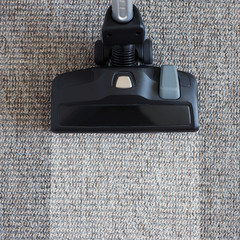 housekeeping before and after concept - modern vacuum cleaner over carpet floor
