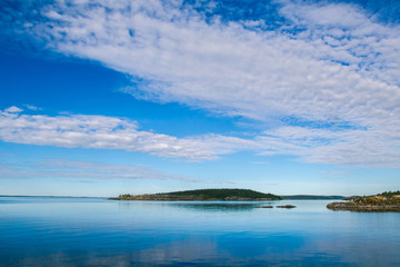 Island. Clouds over the island. Karelia. Ladoga lake. Summer day in Karelia. Russia.
