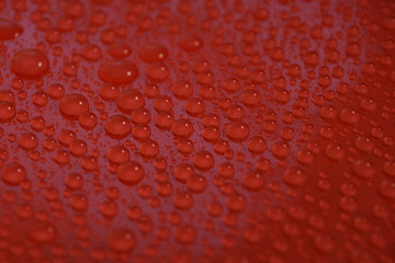 water drops on red background texture