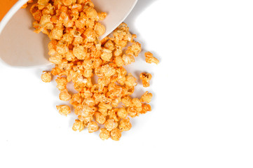 Popcorn pourring out the paper cup isolated on the white background