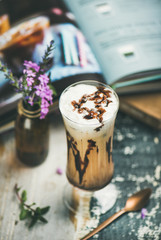 Iced mocha coffee with whipped cream, ice cream and chocolate sauce, served in tall glass over...