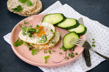 Breakfast fried egg, micro greens and bread.