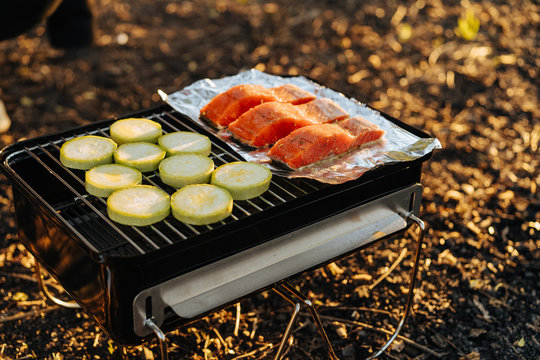 grill with salmon and vegetables on griddle