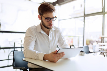Busy businessman enjoying coffee while online