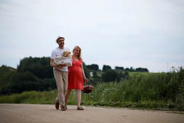 Pregnant girl with big belly and young man outdoor