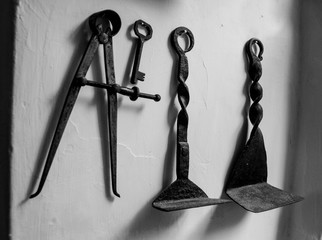 old metal work tools hanging on the wall