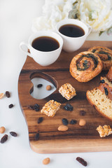 Two cup of black coffee with sweet bread on the wooden table