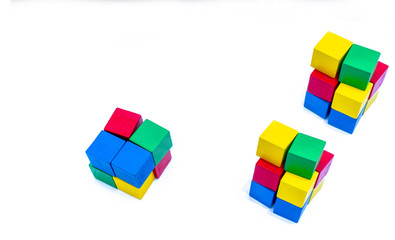 Stack of bright color wooden building block isolated on white background. Blue, red, green, and yellow cube blocks. Kids, baby and child toy help boost fine motor skills and small muscle development