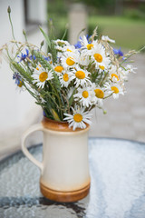 Midsummer in Latvia: celebration of Ligo in june decorating home with field flower bouquet