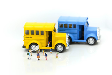 Miniature people : A group of young children getting on the schoolbus,schoolbus transportation education