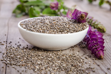 Chia seeds healthy superfood with flower on wooden table