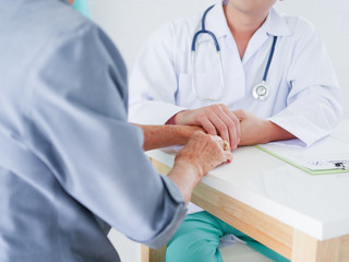 Close up Doctor hands holding elderly woman hands in hospital .Health care concept.