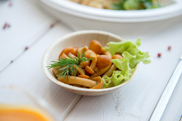 Pickled Mushrooms with salad on eco plate.