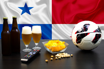 2 bottles of beer, 2 glasses of beer next to the football on the background of the flag of Panama.