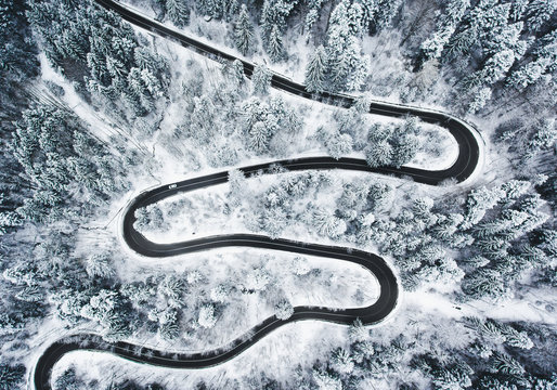 Winding winter road in and forest whit trees covered in snow