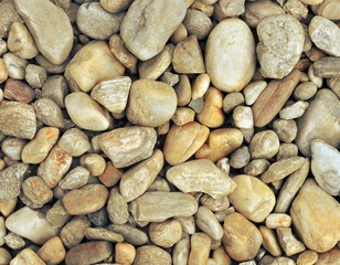 Different sized stones on the pavement, top view, retro style