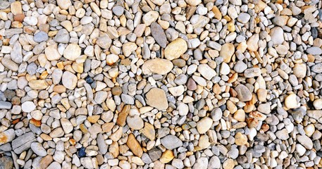 Colorful and different sized stones on the road, top view, retro style