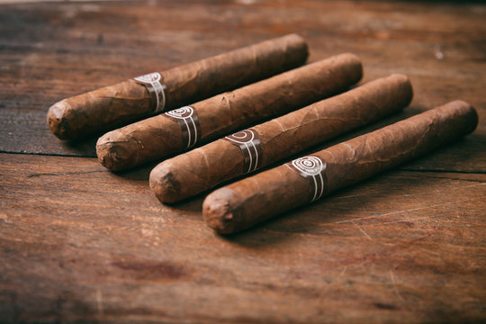 Cigars on wooden background, copy space