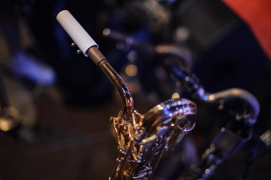 Gold trumpet standing on the floor on the blurred background