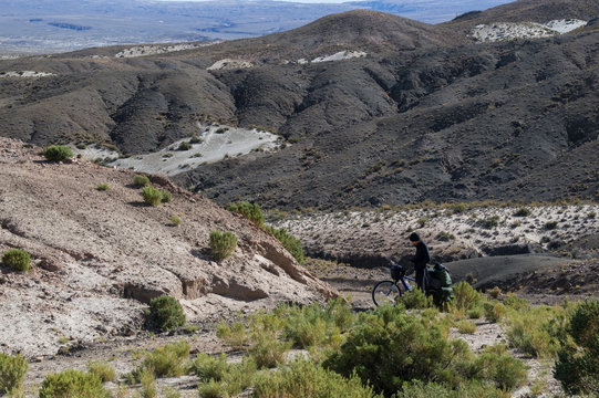 man with his bike on the bolivian highland