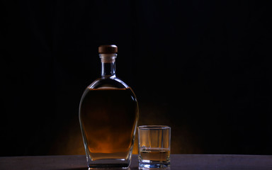 A bottle and a glass of alcoholic drinks