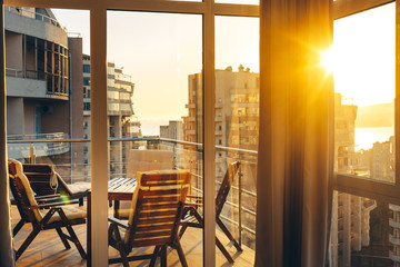 Summer Terrace With Garden Furniture In The Background Of The City And Sunset. Luxury Apartments...