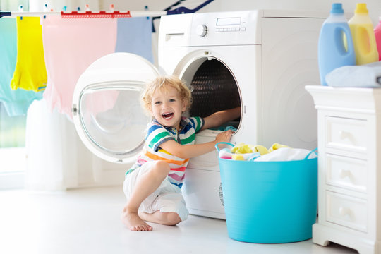 Child In Laundry Room With Washing Machine