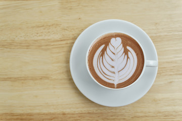 cup of hot coffee on wood floor.