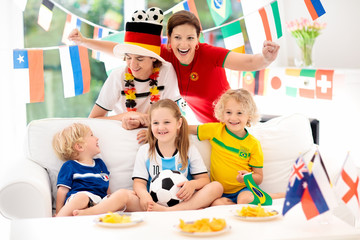 Fototapeta premium Fans watch football game. Family watching soccer.