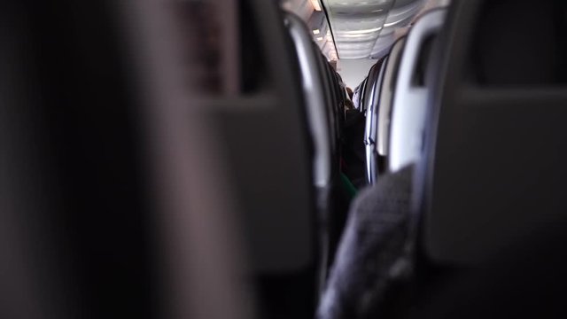 Interior of airplane with passengers on seats. shaking because of turbulence