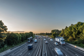 Sunset view heavy traffic moving at speed on UK motorway in England