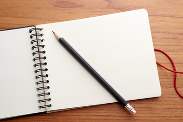 Writing on Notebook With Pencil