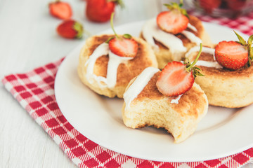 Obraz na płótnie Canvas Homemade cottage cheese pancakes with sour cream and fresh strawberry on white wooden background. Healthy breakfast.