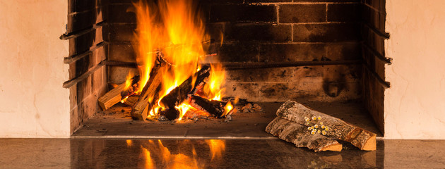 Burning firewood in the fireplace in the evening