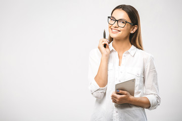 Young beautiful smiling woman in glasses holding pen, isolated on white. Business concept with...