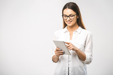 Portrait with copy space empty place of pretty charming confident trendy woman in classic shirt having tablet in hands looking at camera isolated on white background