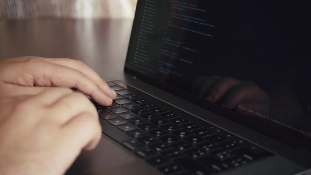 programmer working in office writing programming code (there is no possible trademark or copyright infringement with programming code)