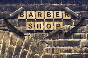 Concept Barber Shop. An inscription on wooden cubes against the background of an old vintage wall.