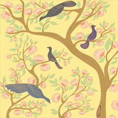 Paradise birds on the branches of a flowering tree in the garden