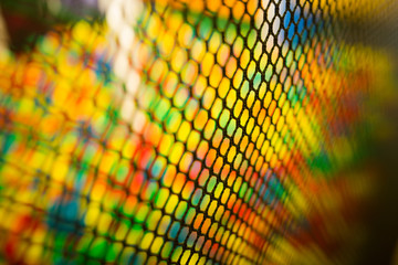 black mesh and a children's entertainment center in the blur. multicolored background