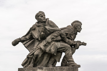 Second world war memorial, Hrabyne, Czech Republic / Czechia - statue of Soviet soldiers from Red Army. Warriors are fighting with grenades and guns. Heroic and iconic warfare