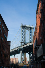 Fototapeta na wymiar A view of Manhattan Bridge from between two buildings in Brooklyn
