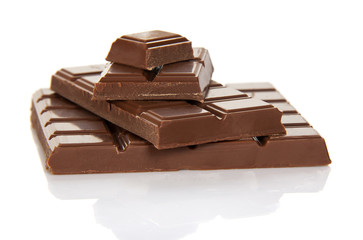 The whole tile of milk chocolate and slices isolated on white