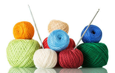 Cotton yarn balls of different shades and crochet hooks, isolated on white