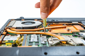 Obraz premium Computer repair technician is repairing the notebook or repair laptop.