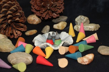 Colorful incense cone on black background