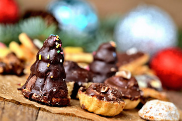 Close-up of christmas sweets with different types of candy on baking paper and Christmas decorations